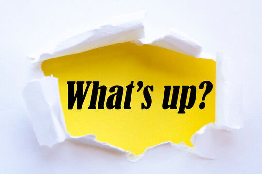 Naklejki “What’s up?” word written under torn paper.