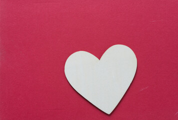 Obraz premium wooden heart on a red background