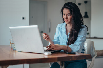 Businesswoman using laptop while working in the office