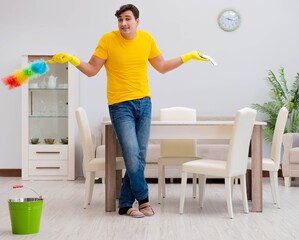 Man husband cleaning the house helping his wife