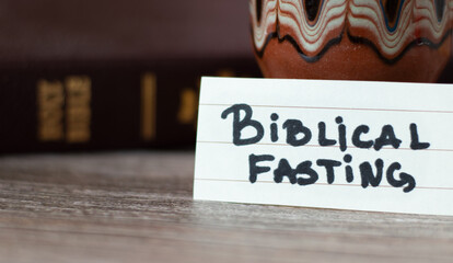 Biblical fasting concept. A close-up of handwritten text with Holy Bible Book. Faithful Christian...