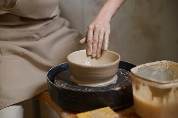 A picture of a potter working on a pottery wheel