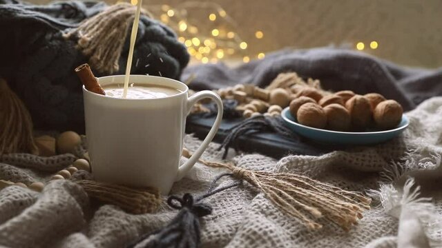 scandinavian style cozy morning with some knitted blankets, cacao mug, gift box, winter and festive mood, cristmas vibe. High quality FullHD footage