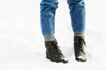 Legs of stylish young woman on snowy day