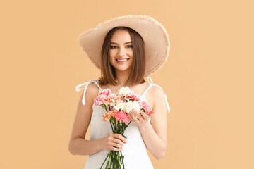 Beautiful young woman with bouquet of carnations on color background