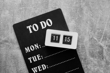 Chalkboard and alarm clock on grey textured background. Time management concept
