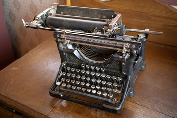 Old antique black typewriter on a desk
