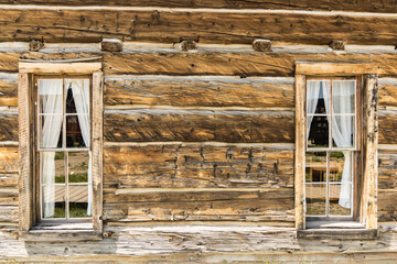Old weathered wood windows on rustic log cabin