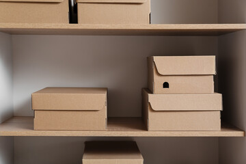 Cardboard boxes on shelf in wardrobe