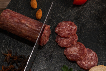 star anise meat table sausage almonds and grapes cheese