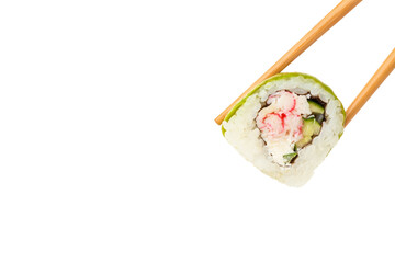 Chopsticks taking delicious sushi roll with avocado on white background