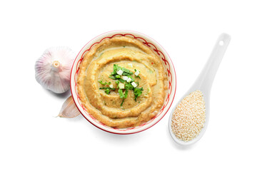 Bowl with tasty baba ghanoush, garlic and sesame on white background
