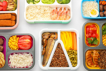 Many containers with various food on white background, closeup