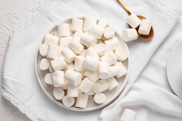 Fototapeta na wymiar Plate with tasty marshmallows on light background