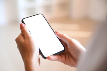 Woman with mobile phone in office, closeup