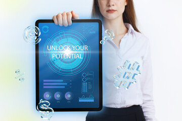 Business, Technology, Internet and network concept. Young businessman working on a virtual screen of the future and sees the inscription: Unlock your potential
