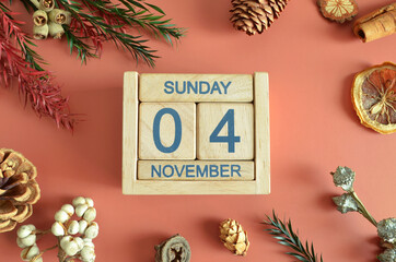 November 4, Cover design with calendar cube, pine cones and dried fruit in the natural concept.