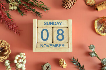 November 8, Cover design with calendar cube, pine cones and dried fruit in the natural concept.