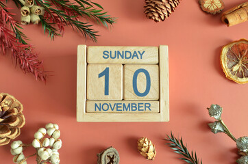 November 10, Cover design with calendar cube, pine cones and dried fruit in the natural concept.