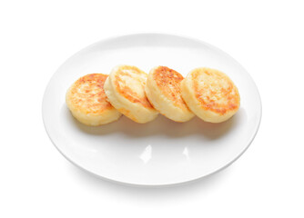 Plate with cottage cheese pancakes on white background