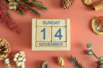November 14, Cover design with calendar cube, pine cones and dried fruit in the natural concept.