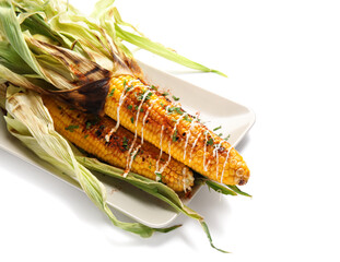 Plate with delicious grilled Mexican street corn on white background, closeup