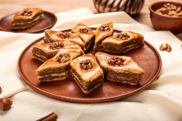 Plate with tasty baklava on table