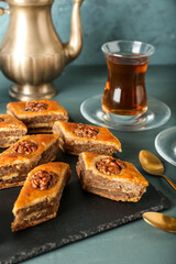 Board with tasty baklava on table