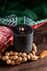 Burning candle, tasbih and flag of Afghanistan on wooden background
