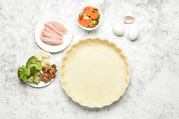 Obraz na płótnie Canvas Raw dough and ingredients for preparing pot pie on light background
