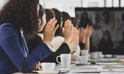 Six asian business women sitting on the table wave greeting on online conference call meeting through screen in office. Concept for online meeting