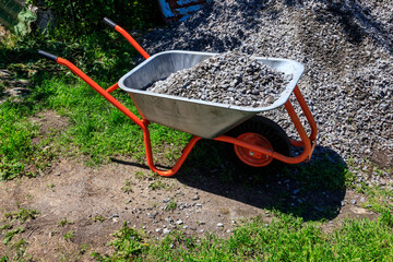 Wheelbarrow with gravel at the construction site