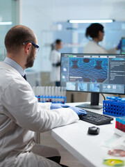 Chemist researcher doctor typing virus expertise working at coronavirus treatment during...
