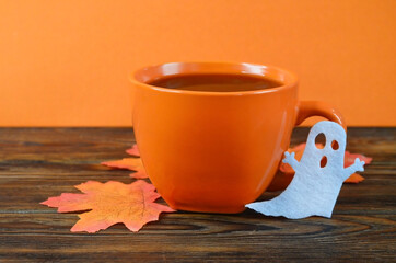 autumn halloween background with cup of coffee drink,greeting card with copy space text,  halloween and festive holiday item