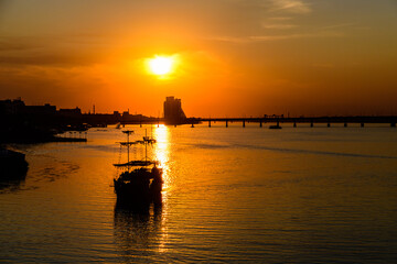 Fototapeta na wymiar Beautiful sunset over the river Dnieper. Ship against sunset. Dnipro, Ukraine