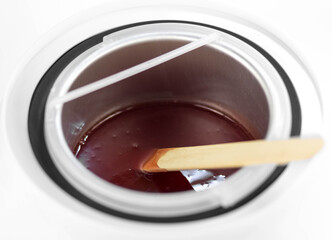 Cupping wax. A cup for melting wax. Depilation agent