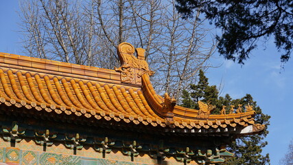 The typical classical Chinese temple buildings view with the red wall, door and golden tiles roof designation