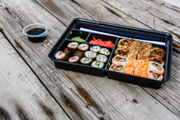 Set of the different sushi on wooden table