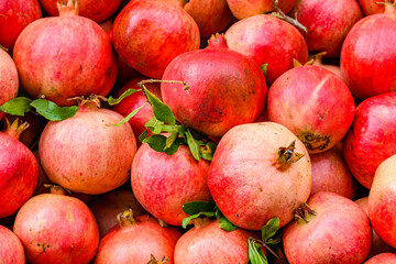 Many pomegranates for sale at the market. Fruit background