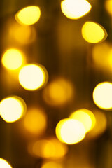 Golden abstract background with defocused bokeh lights. Round bokeh christmas light. Template for a greeting card for fun.