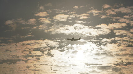 One airplane flying in the sunset sky with the colorful clouds as background