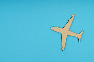 The wooden airplane flies up. Isolated on a blue background.