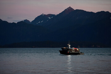 A fishing boat returns to the Homer, Alaska, harbor on Kachemak Bay.