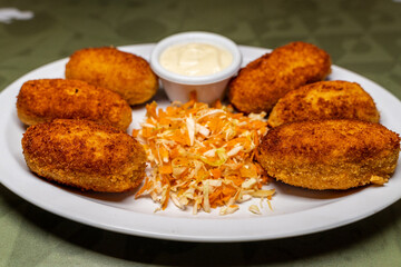 Dish of croquettes with mayonnaise sauce and vegetables