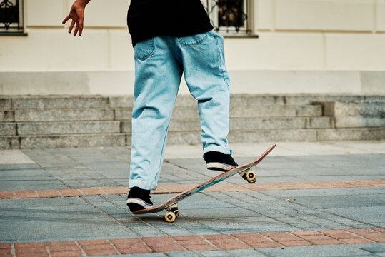 Skateboarder ride on skateboard at city street. Scater practice skate board tricks at skatepark. Teenager extreme sport