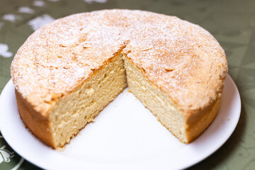 Incomplete round santiago cake with sugar sprinkled on top