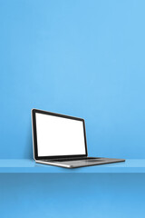 Laptop computer on blue shelf. Vertical background