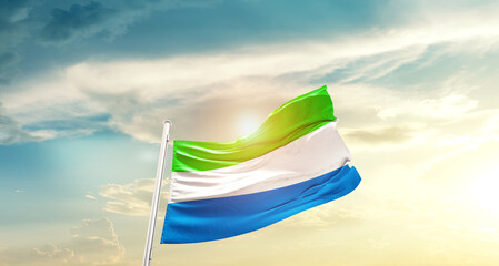 Sierra Leone national flag cloth fabric waving on the sky - Image