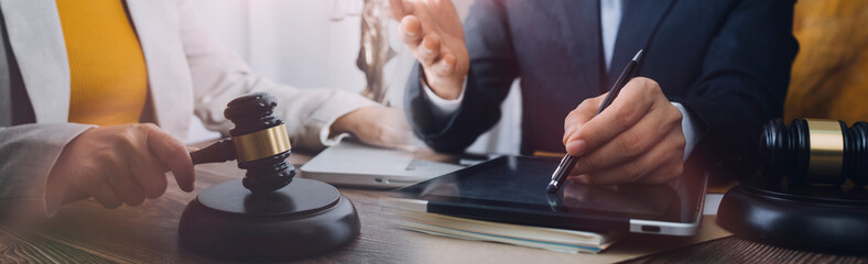 justice and law concept.Male judge in a courtroom on wooden table and Counselor or Male lawyer...