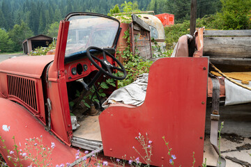 The open cab of an antique fire truck in a junkyard, Idaho, USA